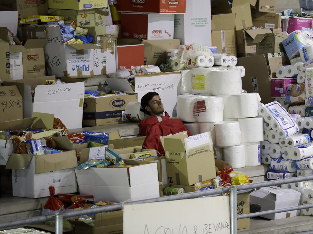 A volunteer takes some rest in a makeshift camp set up inside a gymnasium following an earthquake, in Amatrice, central Italy, Thursday, Aug. 25, 2016. Rescue crews rattled by aftershocks dug through crumbled homes Thursday looking for earthquake survivors as donations began pouring into the area and Italy again anguished over its failure to protect ancient towns and modern cities from the country's highly seismic terrain. (AP Photo/Andrew Medichini)