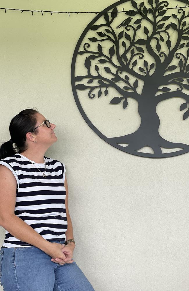 Kelly Moreland is pictured with a tree of life that hangs on her patio wall at her Marian home in memory of her brother. Picture: Janessa Ekert