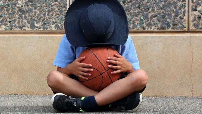 Unhappy child in the schoolyard.