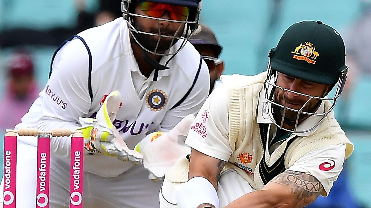 Australian batsman Matthew Wade plays a shot as Indian wicketkeeper Rishabh Pant (L) looks on during the day two of the third cricket Test match at Sydney Cricket Ground (SCG) between Australia and India on January 8, 2021. (Photo by Saeed KHAN / AFP) / —IMAGE RESTRICTED TO EDITORIAL USE - NO COMMERCIAL USE —