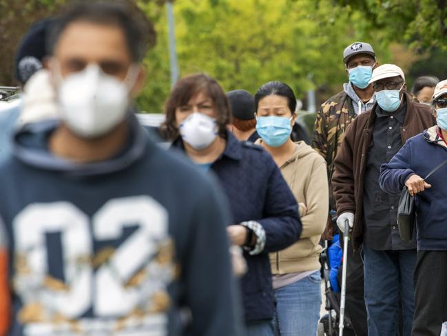 New Yorkers line up for free masks in the borough of Queens. Picture: AP