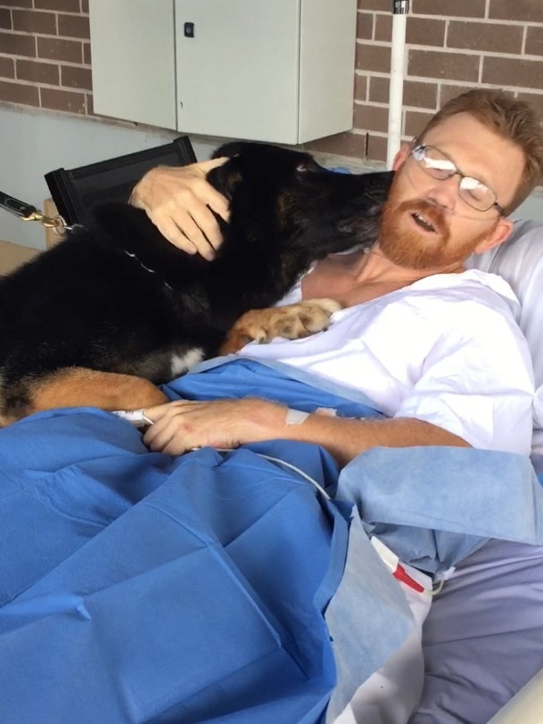 Luke Warburton’s “best mate” Chuck sees him in hospital for the first time after he was shot and nearly died on the job in 2016. Picture: Supplied