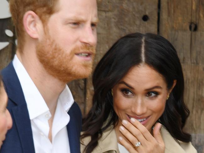 TOPSHOT - Britain's Prince Harry and his wife Meghan meet a koala named Ruby and its koala joey named Meghan after the Duchess of Sussex during a visit to Taronga Zoo in Sydney on October 16, 2018. - Prince Harry and Meghan have made their first appearances since announcing they are expecting a baby, kicking off a high-profile Pacific trip with a photo in front of Sydney's dazzling Opera House and posing with koalas. (Photo by DEAN LEWINS / POOL / AFP)