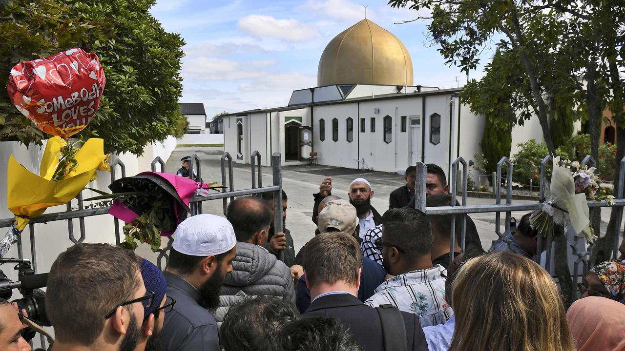 People queue at the gates of the Al Noor mosque after is was reopened in Christchurch this afternoon. Picture: William West/AFP