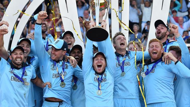 Eoin Morgan lifts the World Cup trophy as England's players celebrate their win