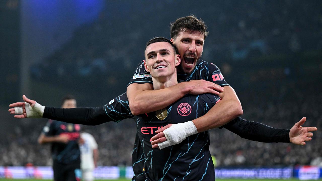 Manchester City's English midfielder #47 Phil Foden (front) celebrates scoring with Manchester City's Portuguese defender #03 Ruben Dias during the UEFA Champions League round of 16, first-leg football match between FC Copenhagen and Manchester City in Copenhagen, Denmark, on February 13, 2024. (Photo by Jonathan NACKSTRAND / AFP)