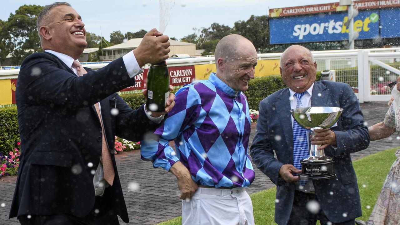 MRC chairman John Kanga sprays champagne on owner Tony Ottobre and jockey Craig Newitt after Pride Of Jenni’s win. Picture: Vince Caligiuri/Getty Images