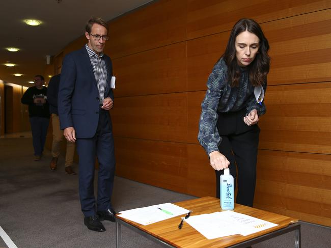 WELLINGTON, NEW ZEALAND - APRIL 19: Prime Minister Jacinda Ardern and Director-General of Health Dr Ashley Bloomfield use hand sanitiser on their way into a press conference at Parliament on April 19, 2020 in Wellington, New Zealand. New Zealand has been in lockdown since Thursday 26 March following tough restrictions imposed by the government to stop the spread of COVID-19 across the country.  Prime Minister Jacinda Ardern on Thursday announced that restrictions could be eased as of next week if the government decides to move to COVID-19 Alert Level Three. Under the current COVID-19 Alert Level Four measures, all non-essential businesses are closed, including bars, restaurants, cinemas and playgrounds. All indoor and outdoor events are banned, while schools have switched to online learning. Essential services remain open, including supermarkets and pharmacies. A decision on whether or not to lift the level four lockdown measures will be made during a cabinet meeting on Monday 20 April followed by an announcement at 4pm New Zealand time. (Photo by Hagen Hopkins/Getty Images)