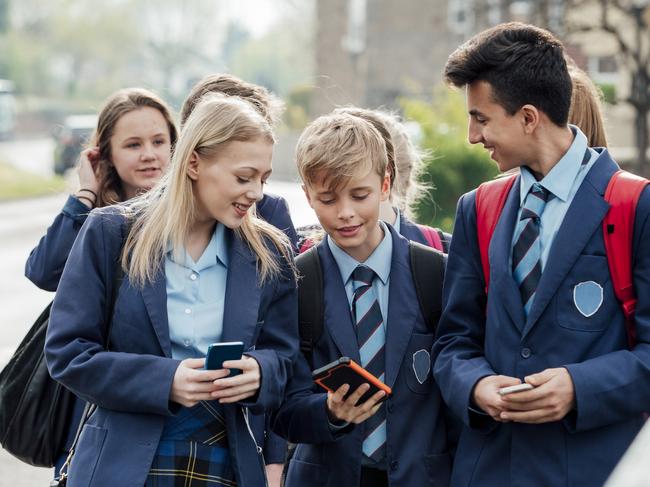 Group of teenage students walking home from school together.