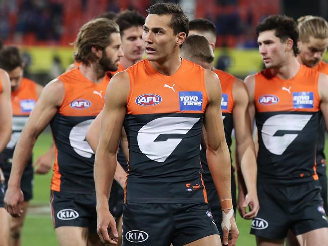 CANBERRA, AUSTRALIA - APRIL 23: IsaacÃÂ Cumming of the Giants and team mates look dejected after the round six AFL match between the Greater Western Sydney Giants and the Western Bulldogs at Manuka Oval on April 23, 2021 in Canberra, Australia. (Photo by Matt King/AFL Photos/via Getty Images )