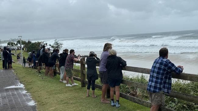 Spectators gathered on the shores of beaches at Byron Bay to watch the thunderous waves. Picture: Matt Condon