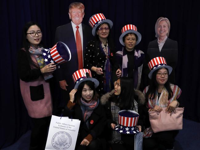 Women pose with cutouts of U.S. presidential candidates of Democrat Hillary Clinton and Republican Donald Trump during a presidential election event held at the U.S. embassy in Beijing, Wednesday, Nov. 9, 2016. (AP Photo/Andy Wong)