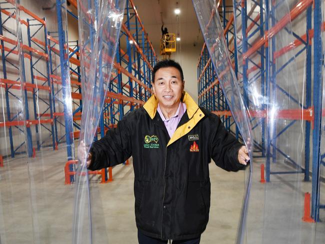 Nelson Lay proudly stands in the new Asian United Food premises after it was burnt to the ground last year. Picture: Katrina Bridgeford