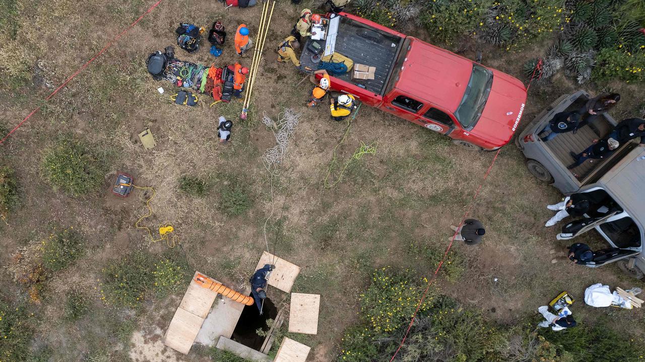 Rescue workers and Mexican authorities search a waterhole where human remains, believed to be two missing Perth brothers, near La Bocana Beach in Baja California State, Mexico. Picture: Guillermo Arias / AFP