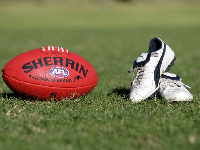 Generic AFL Sherrin football and football boots. sport /