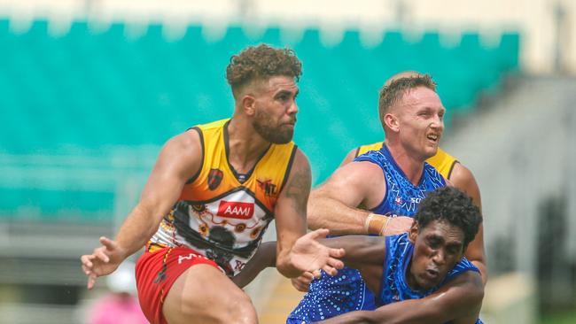 Central Australian Redtail Nigel Lockyer Jr goes long despite the attention of Big Rivers pair Adam Parry, top and Keelan Kelly. Picture: GLENN CAMPBELL