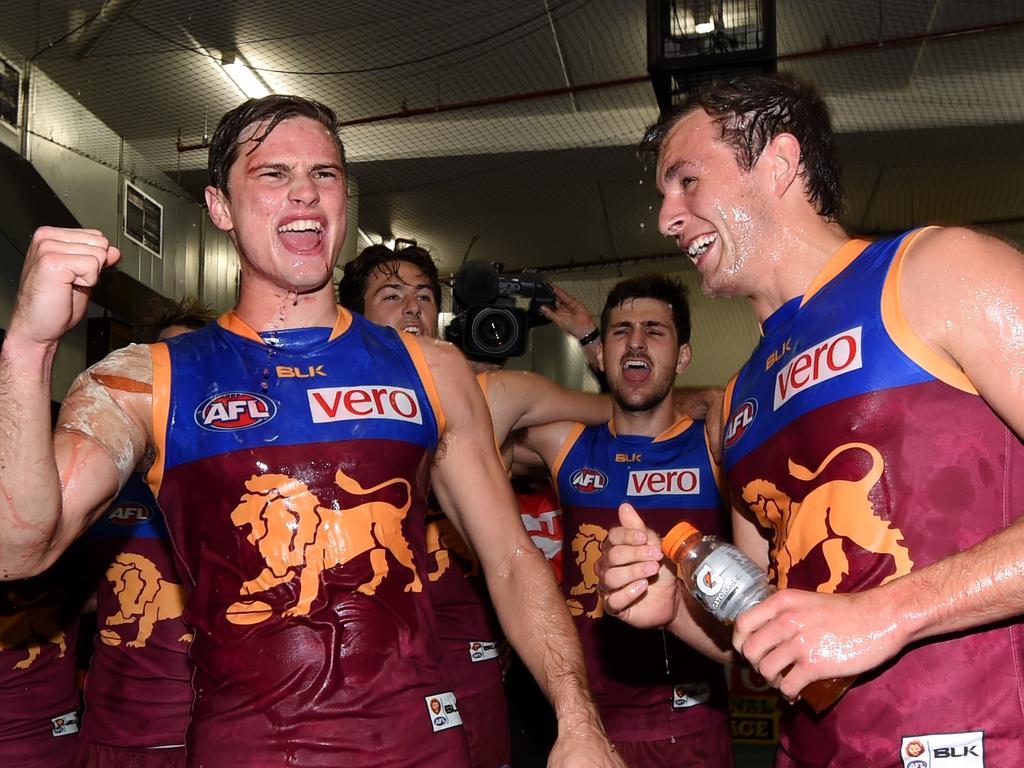 Brisbane players Liam Dawson and Billy Evans sing the song after beating Carlton.