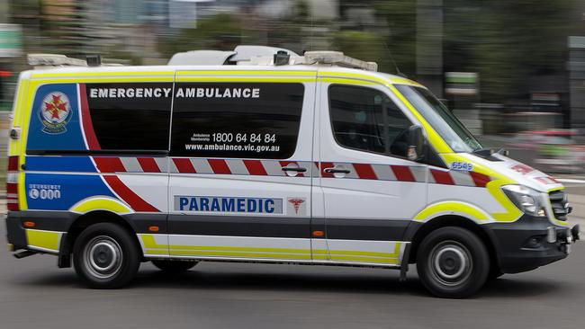 MELBOURNE, AUSTRALIA - NewsWire Photos FEBRUARY 13, 2022: An ambulance speeds away from the Royal Melbourne Hospital. Ambulance, Generic.Picture: NCA NewsWire / David Geraghty