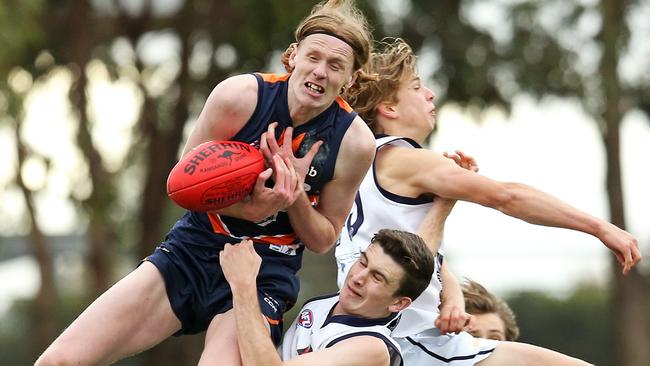 Mason Fletcher juggles a mark against Geelong Falcons.