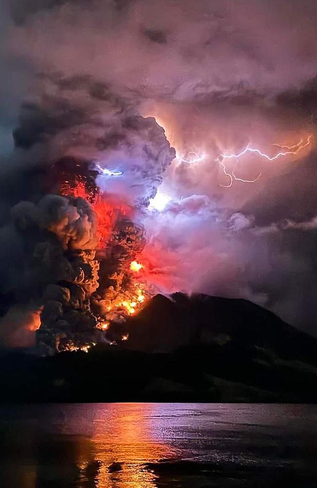 Mount Ruang in North Sulawesi violently erupts, casting a column of smoke and lava more than a mile into the sky. The overnight eruption prompted the evacuation of hundreds in Indonesia’s outermost region. Picture: Center for Volcanology and Geological Hazard Mitigation/AFP