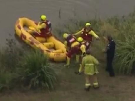 QFES teams are performing a swift water rescue at a dam in Jimboomba. Credit: 7News