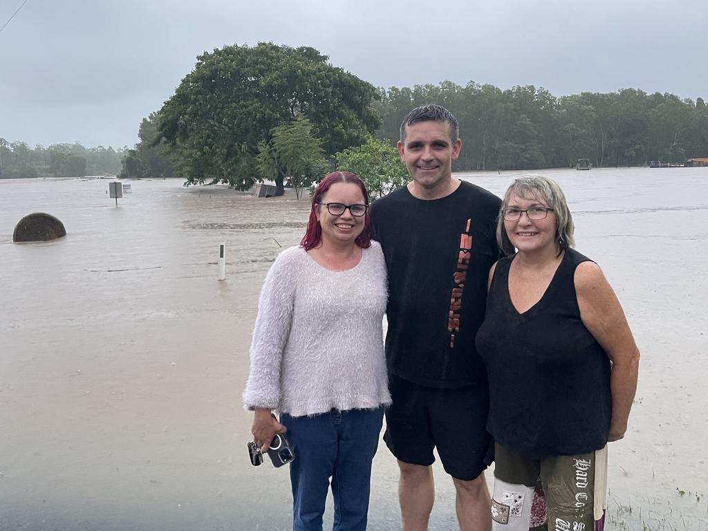 New Gargett residents (from left): Sara Mattson, Wade Tucakovic, and Jan Williams, sightseeing the floodwaters over Cattle Creek along Mackay-Eungella Rd, January 16, 2023. Picture: Janessa Ekert