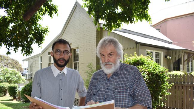 Councillor Jonathan Sri (The Gabba) and local historian Geraint Gregory check historical records on a brick cottage next to Mowbray Park. Picture: Brian Bennion