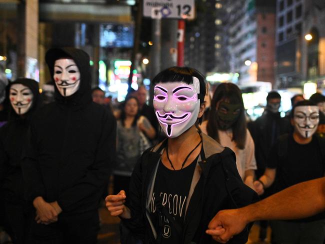 People wearing Guy Fawkes mask take part in a march to Central district during Halloween, in defiance of Hong Kong leaders. Picture: AFP