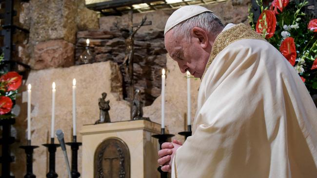 The Pope prays at the tomb of St Francis in Assisi on Saturday. Picture: AFP