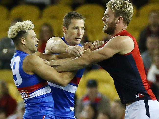 AFL : Round 13 : Western Bulldogs vs. Melbourne at Etihad Stadium, 18th June, , Melbourne Australia.  Melbourne's Jack Watts gets into Western Bulldogs Jason Johannisen, with Western Bulldogs Dale Morris and Melbourne's Tomas BuggPicture : George Salpigtidis