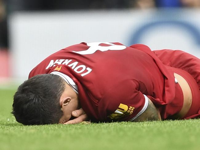 Liverpool's Croatian defender Dejan Lovren lies injured after a tangle with  Manchester United's Belgian striker Romelu Lukaku during the English Premier League football match between Liverpool and Manchester United at Anfield in Liverpool, north west England on October 14, 2017. / AFP PHOTO / Paul ELLIS / RESTRICTED TO EDITORIAL USE. No use with unauthorized audio, video, data, fixture lists, club/league logos or 'live' services. Online in-match use limited to 75 images, no video emulation. No use in betting, games or single club/league/player publications.  /