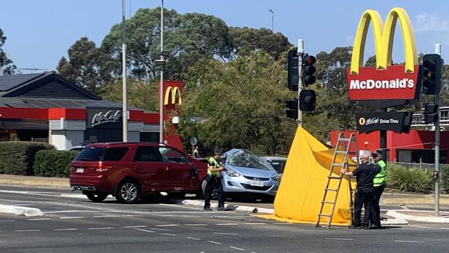 Fatal car crash at Golden Grove 2024: Emergency services put up a screen around the crash which involved a silver sedan and red four-wheel drive. Picture: George Yankovich