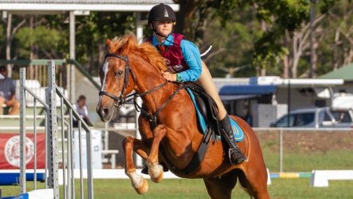 Marli Ferrington and her mount Basil clear the tower fence at the PQC State Showjumping Championships.