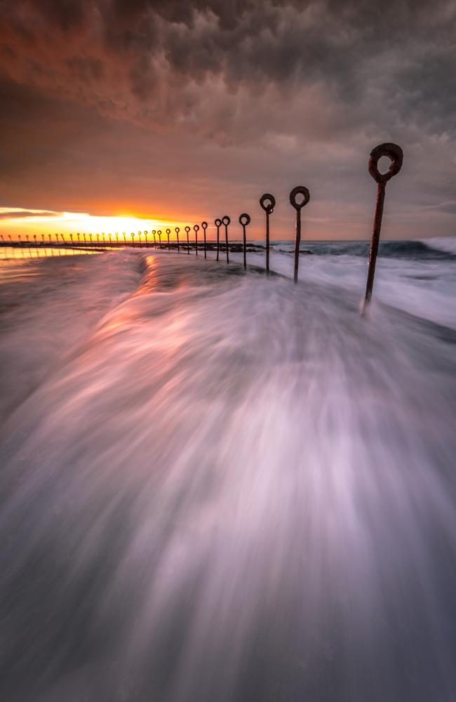Landscape winner: Andy Smith ... Andy Smith says that he always tries to convey a sense of drama in his images through the use of powerful foregrounds and moody skies. This shot was taken at the Canoe Pool, Newcastle Ocean Baths. Picture: Andy Smith/Australian Photography magazine