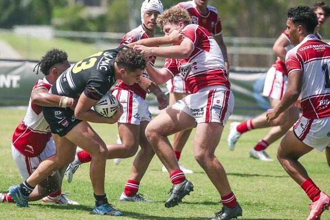 Kobi Hauraki is brought to ground by Redcliffe defenders. Picture: Glenn Campbell
