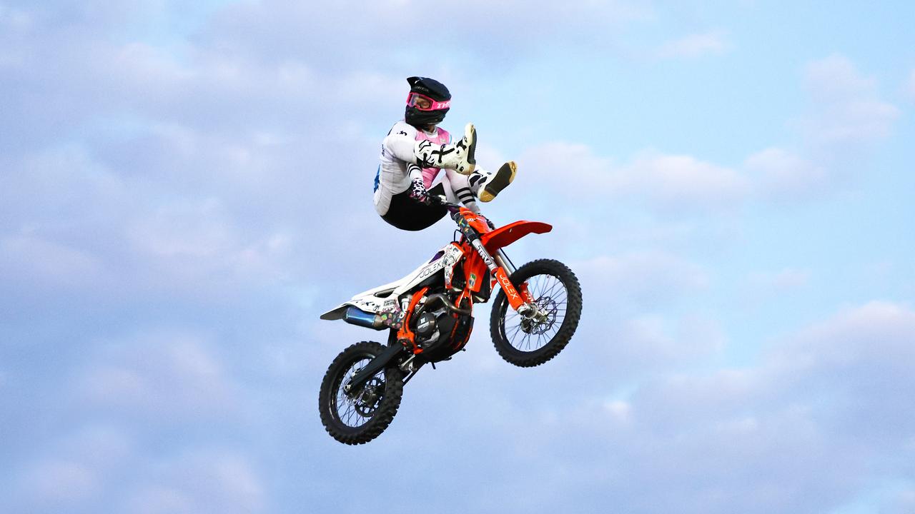 Chevy Olexienko puts his feet over the handlebars on his motocross bike at the 2024 Cairns Bull Throttle event, a bikes and bulls show, featuring bull riding and freestyle motocross riders at the Cairns Showgrounds. Picture: Brendan Radke