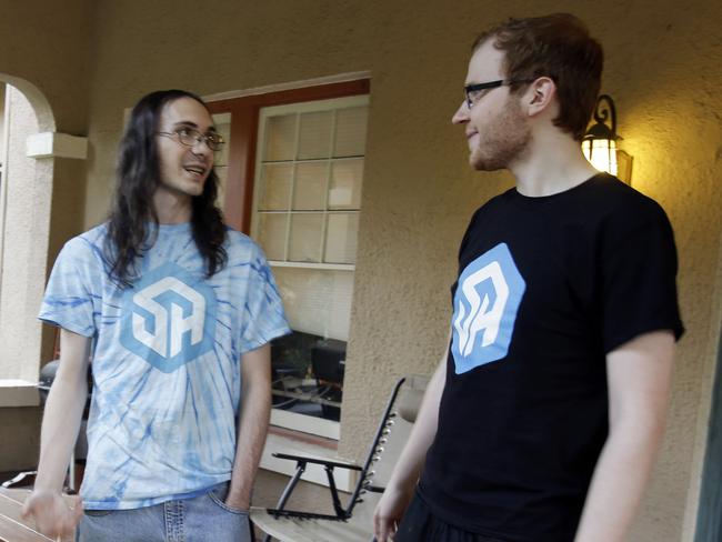 In this Nov. 6, 2014 photo, Brett Borden, left, and Robert Schill take a smoke break outside their 1920s-era Mediterranean-revival home in Lakeland, Fla. They are two of the stars of StreamerHouse, which is a part of Twitch.tv, an online network that attracts tens of millions of visitors, most of whom watch footage of other people playing video games. (AP Photo/John Raoux)