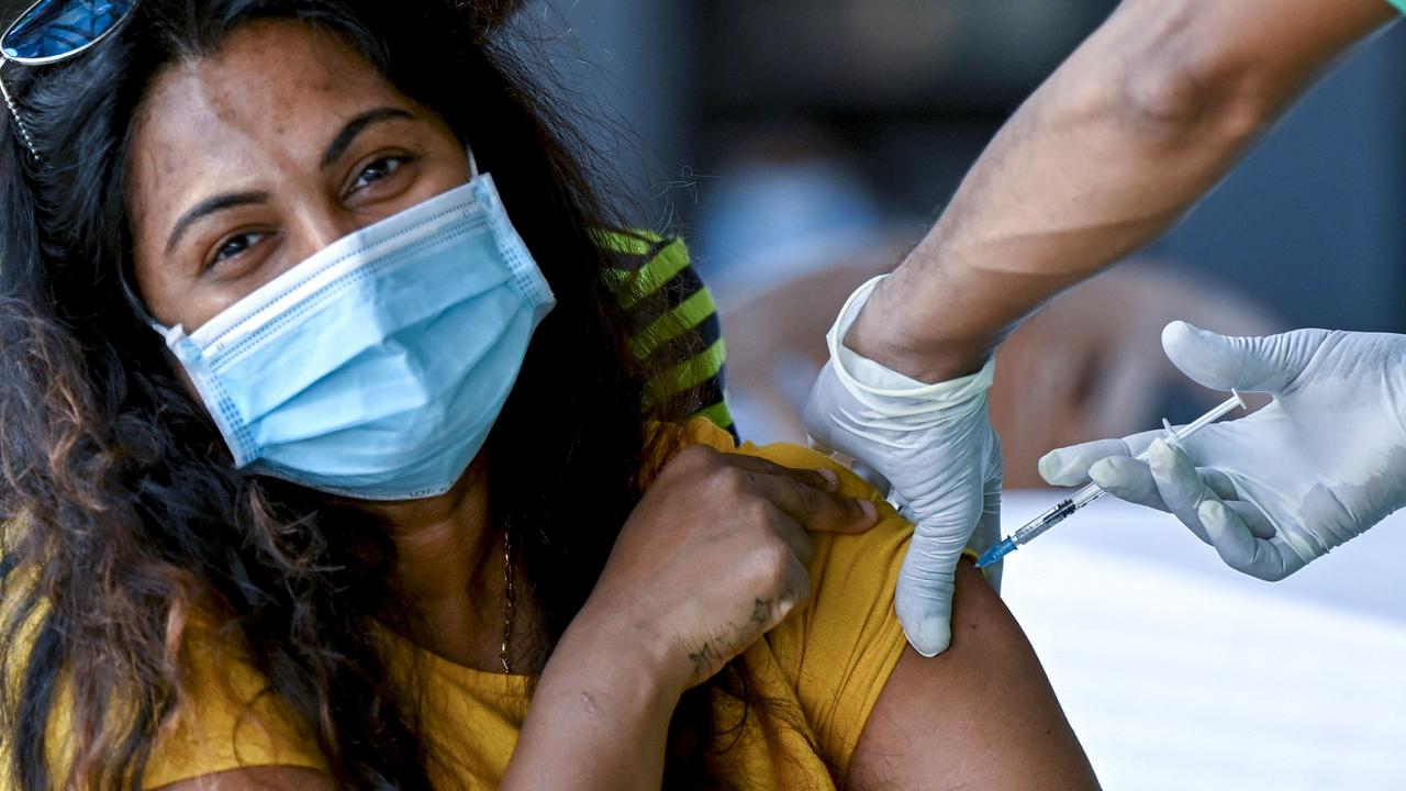 A Sri Lankan medic inoculates a woman with a Covid booster shot in Colombo. Picture: Ishara S. Kodikara/AFP