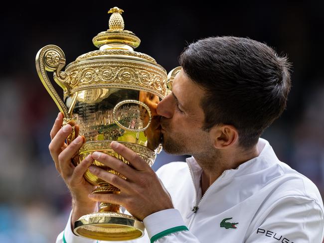 LONDON, ENGLAND - JULY 11: Novak Djokovic of Serbia celebrates with the trophy after winning his men's Singles Final match against Matteo Berrettini of Italy on Day Thirteen of The Championships - Wimbledon 2021 at All England Lawn Tennis and Croquet Club on July 11, 2021 in London, England. (Photo by AELTC/Simon Bruty - Pool/Getty Images)