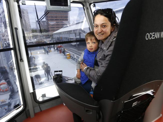 Veronica Gall, of Kingston Beach, and son Hugo, 2, take in the view from the comfort of Ocean Warrior’s modern bridge.