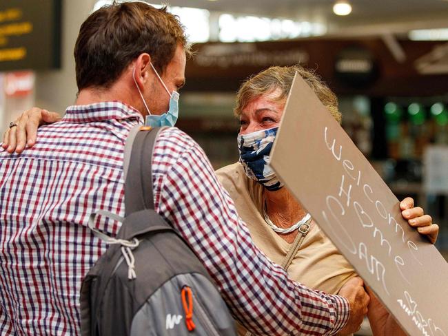 Passengers and loved ones reunite at the arrivals hall at the Auckland international airport. Picture: AFP