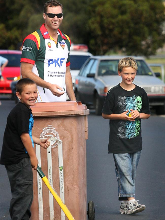 Adam Griffith gets into some street cricket with Jayden Deverell, left, and Zarren Muir in 2009.