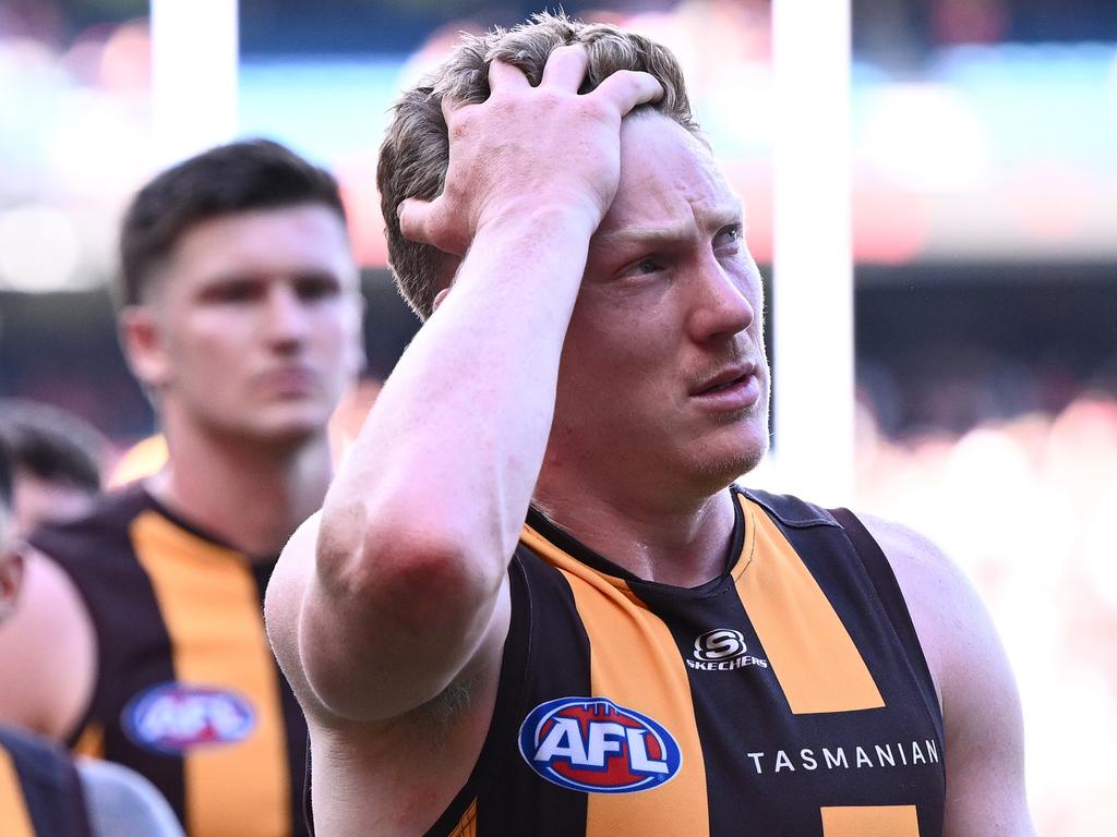 MELBOURNE, AUSTRALIA – MARCH 16: James Sicily of the Hawks and his teammates look dejected after losing the round one AFL match between Essendon Bombers and Hawthorn Hawks at Melbourne Cricket Ground, on March 16, 2024, in Melbourne, Australia. (Photo by Quinn Rooney/Getty Images)