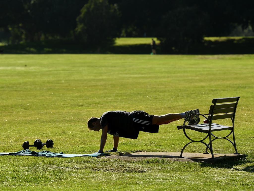 A man exercises alone at a park in Sydney. Picture: Joel Carrett/AAP