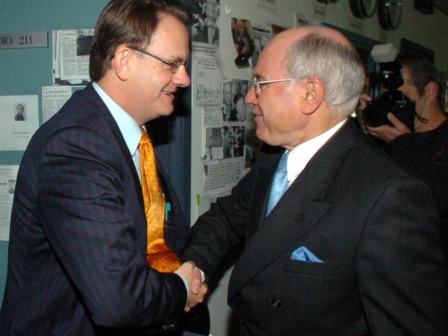 08/10/2004. Australian Prime Minister John Howard (right) shakes hands with Opposition Leader Mark Latham at the ABC radio studios in Sydney during the federal election campaign.