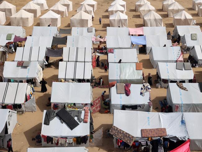 An aerial view shows displaced Palestinians outside tents at a makeshift camp for internally displaced in Rafah, in the southern Gaza Strip. Picture: AFP
