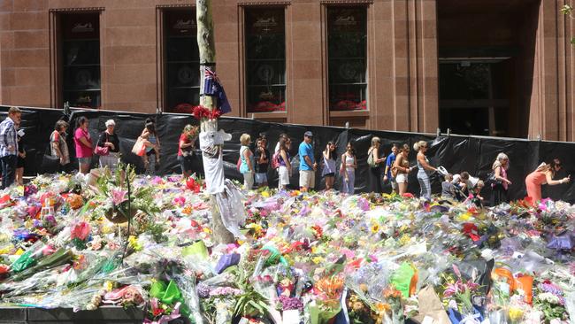 Floral tributes surrounded the siege scene in the days following the incident.