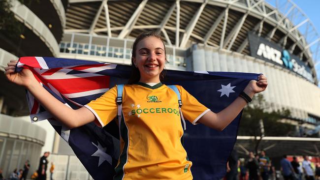 A young Socceroos fan poses outisde the Olympic Stadium.