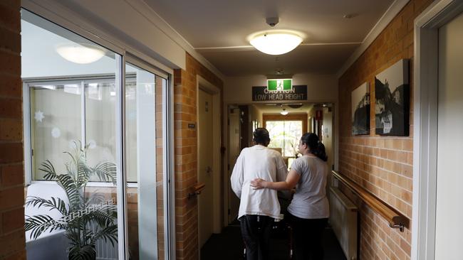 A carer escorts a resident back to their room. Picture: Nikki Short