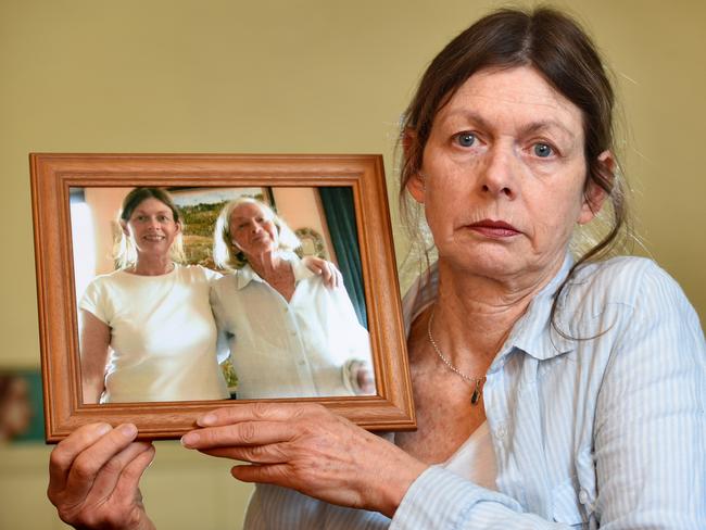 Jane Sinclair was ripped off when booking her mother's cremation. She is one of many Victorians who have been scammed or overcharged at their most vulnerable. Jane pictured holding a photograph of her mother and herself. Picture: Kylie Else